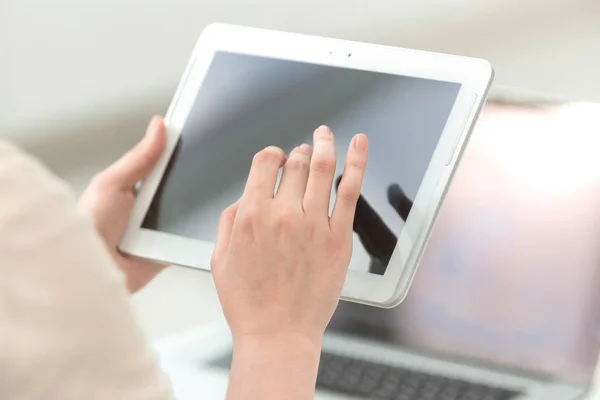 close up. businesswoman pushing using digital tablet.