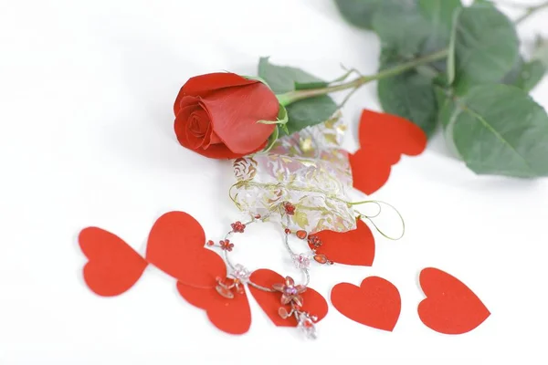 Red rose, jewelry and red hearts on white background — Stock Photo, Image