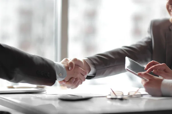 Close up. the financial partners shaking hands over a Desk — Stock Photo, Image