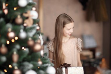 Noel ağacı yakınındaki bir hediye kutusu konumu olan kız .