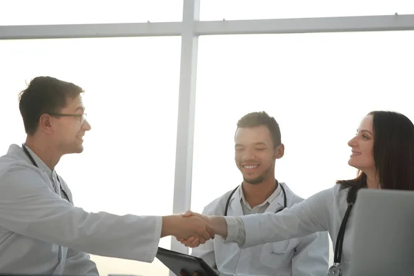 Alsó view.handshake az orvosi munkatársai egy találkozót az irodában. — Stock Fotó