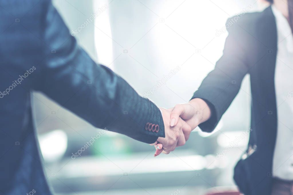 handshake business partners near the workplace in the modern office.