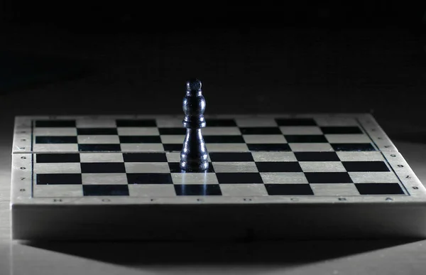 black king on a chessboard . photo with copy space