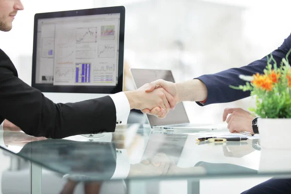 Close up.the background image of a handshake over the Desk — Stock Photo, Image