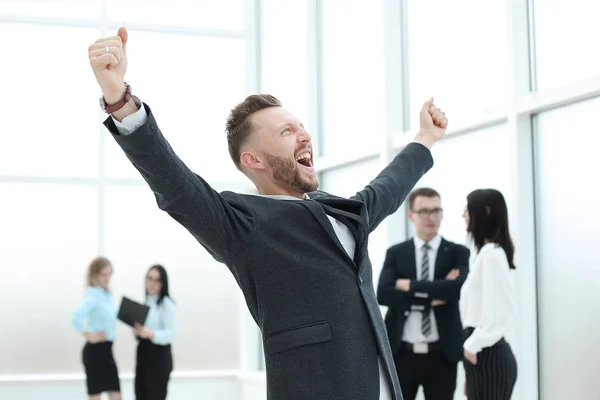 Happy businessman standing in the hall of the business cente — Stock Photo, Image