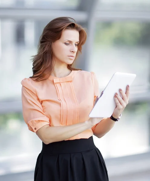 Young business woman with digital tablet in office lobby — Stock Photo, Image