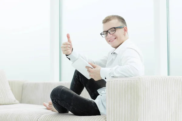 Young man browsing media files on his tablet — Stock Photo, Image