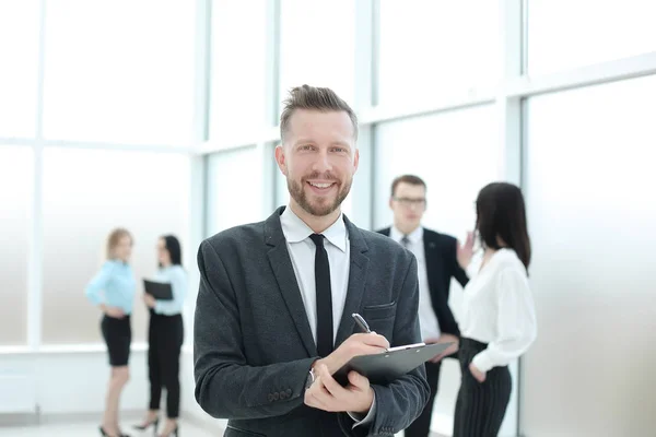 Successful businessman signing document standing in the office — Stock Photo, Image