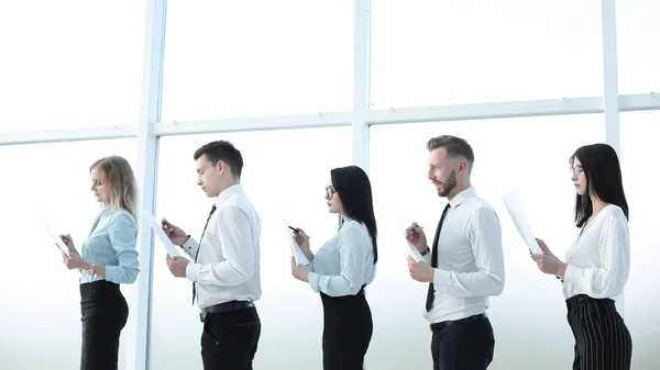 Business team with documents standing in a row. — Stock Photo, Image