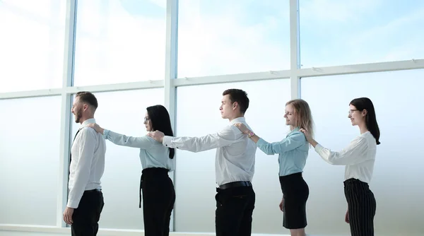 Business team standing together near the office window — Stock Photo, Image