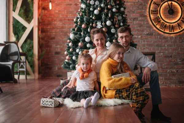 Familia con regalos de Navidad sentado en una acogedora sala de estar — Foto de Stock