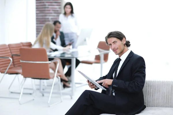 Confident businessman studying the document in his office — Stock Photo, Image