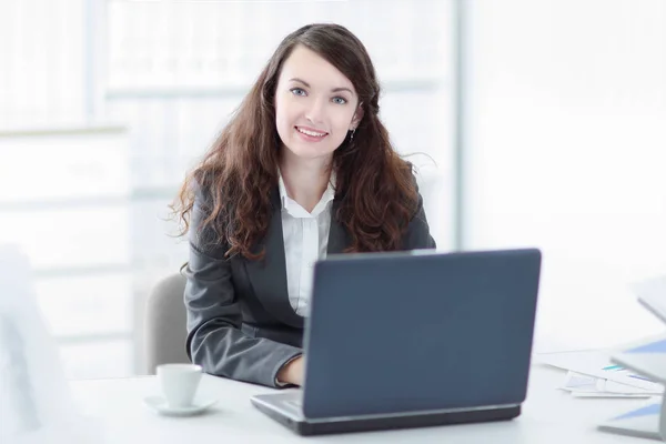 Successful business woman sitting at the Desk in the office Stock Photo