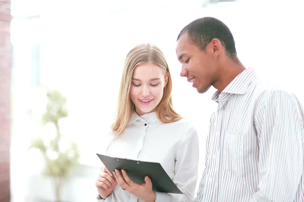 Smiling colleagues in the background of the office — Stock Photo, Image