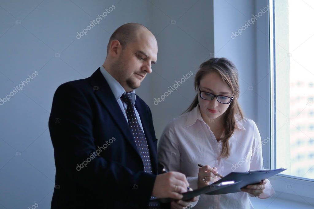 surprised businessman and assistant discussing business documents