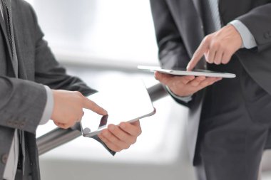 Kapat. Tablet bilgisayarlı iki işadamı