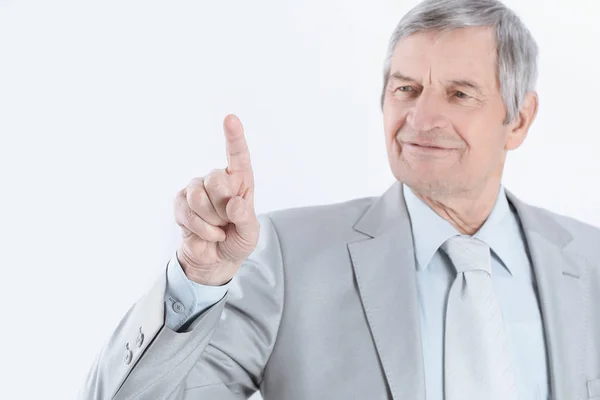 Mature businessman pointing finger to virtual point — Stock Photo, Image