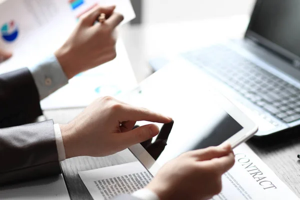 Close up .businessman checking financial data on digital tablet — стоковое фото