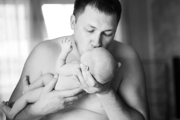 Happy father kissing his newborn daughter. photo in retro style — Stock Photo, Image