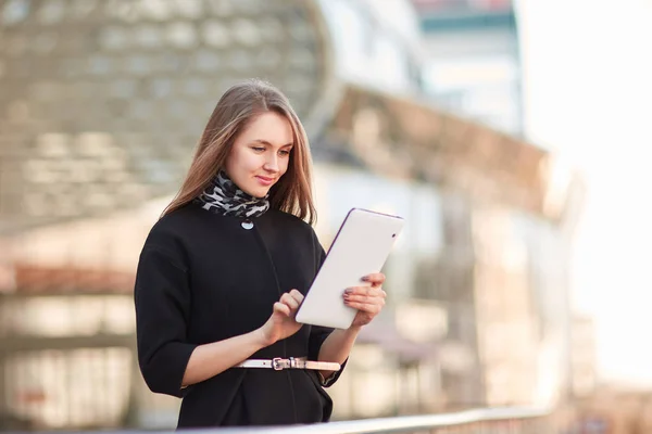 Businesswoman with a digital tablet, standing near the business center — Stock Photo, Image