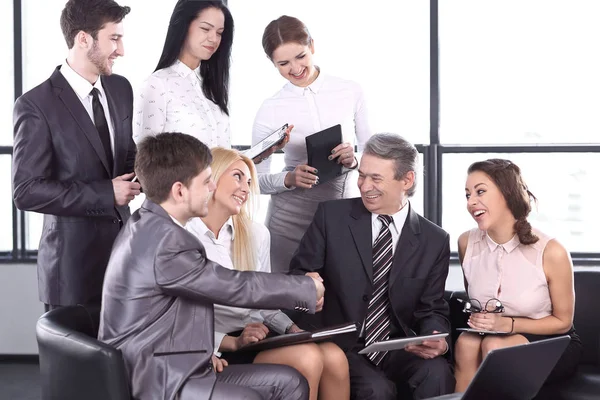 Business partners shaking hands at an informal meeting — Stock Photo, Image