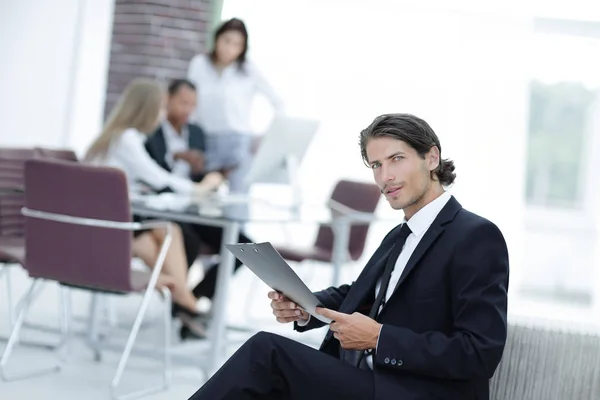 Confident businessman studying the document in his office — Stock Photo, Image