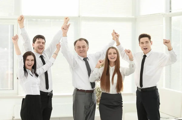 Group of happy young people in formal wear celebrating, gesturing, keeping arms raised — Stock Photo, Image