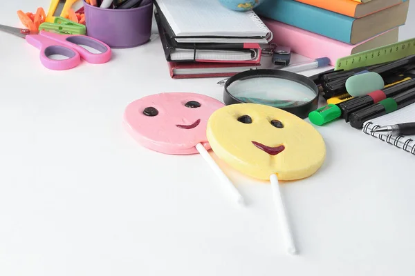 Two candy and school supplies on a white background — Stock Photo, Image