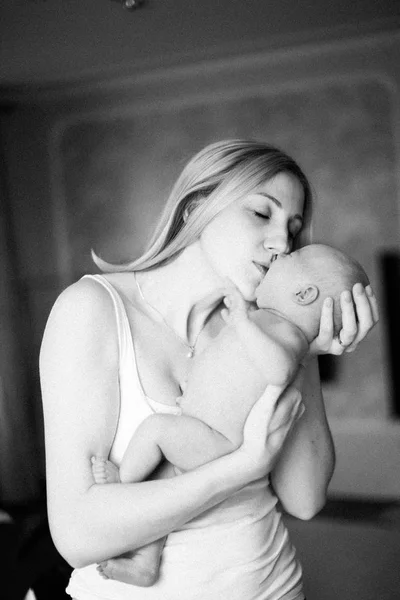 noise-retro photo. happy mother kissing her newborn daughter