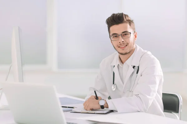 Doctor therapist sitting at a table in his office — Stock Photo, Image