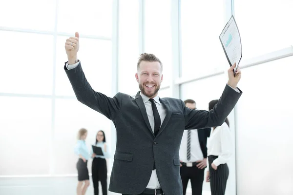 Very happy businessman with new contract standing in office. — Stock Photo, Image