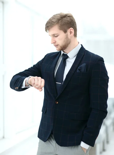 Businessman looking at his watch in office — Stock Photo, Image