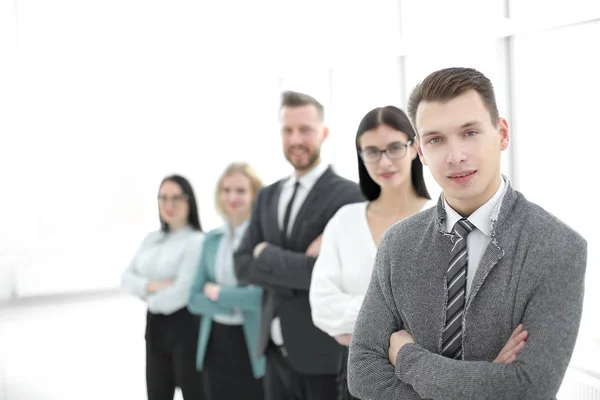 Young businessman standing in front of his business team — Stock Photo, Image