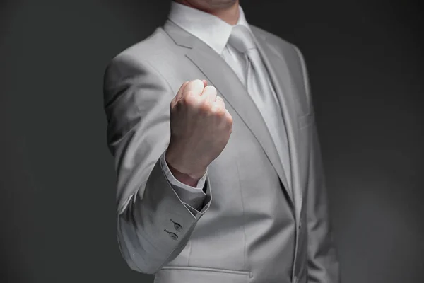 Close up.businessman apretando su mano en un puño .isolated sobre fondo negro —  Fotos de Stock