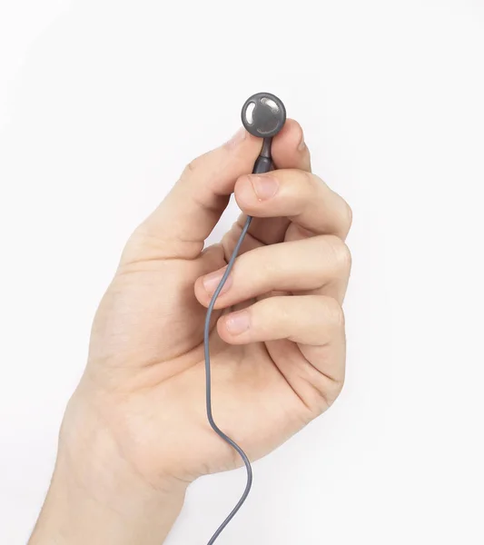 Close-up of the earphone in the hands of men — Stock Photo, Image