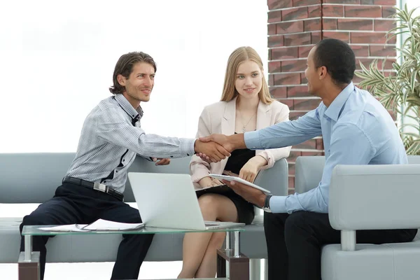 international business partners shaking hands at meeting in the office