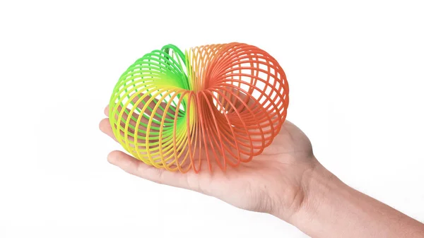 Handen uitgerekt regenboog spiraal. speelgoed uit de kindertijd. — Stockfoto