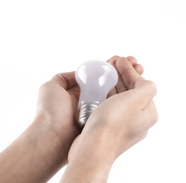 Gloeilamp in de menselijke hand. geïsoleerd op grijze achtergrond — Stockfoto