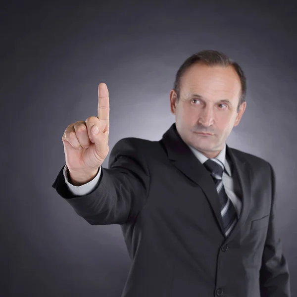 Man in the black suit and tie shows index finger Up — Stock Photo, Image