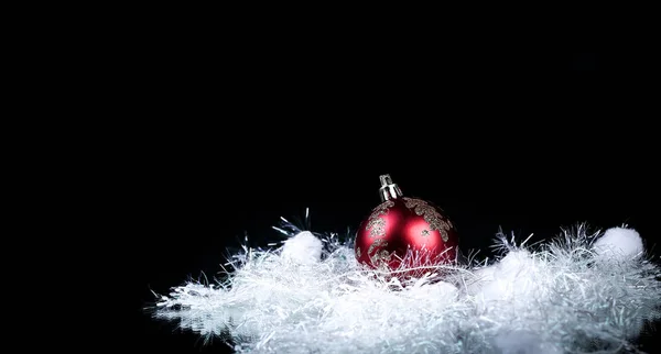 Hermosa bola de Navidad roja sobre un fondo negro. —  Fotos de Stock