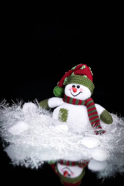 Cute toy snowman on a black background — Stock Photo, Image