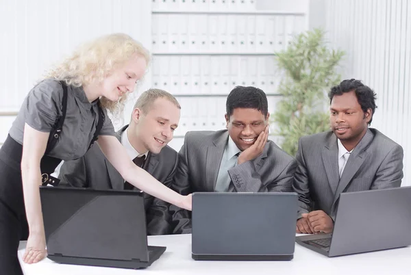 Business team discussing business issues sitting at their Desk — Stock Photo, Image