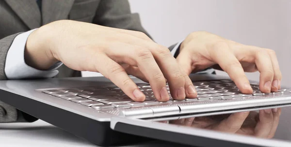 Detailní. obchodník psát na klávesnici přenosného počítače. izolované na bílém pozadí. — Stock fotografie