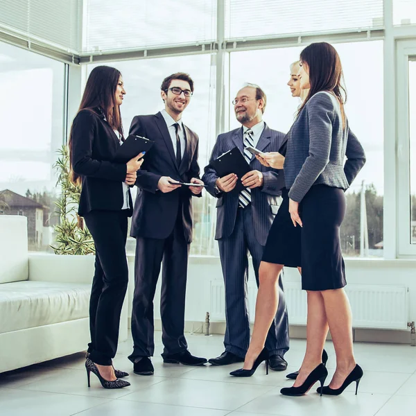 business team discussing work in the spacious lobby of the modern office