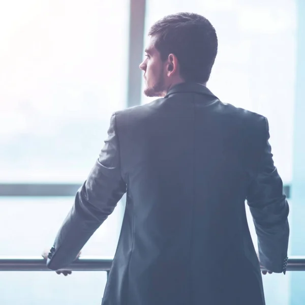 Portrait of a successful handsome businessman in front of a window, there is an empty space for text — Stock Photo, Image
