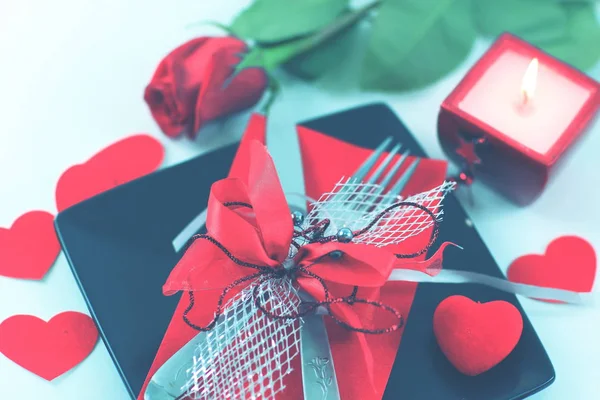 Cutlery on dark plate with a candle decorated for Valentines day — Stock Photo, Image