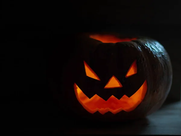 Creepy smiling pumpkin for Halloween on black background. — Stock Photo, Image