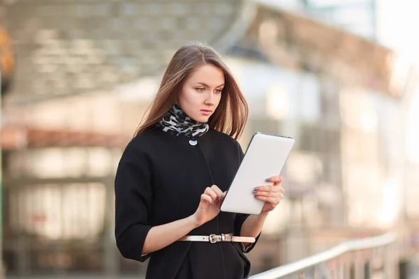 Businesswoman with a digital tablet, standing near the business center — Stock Photo, Image