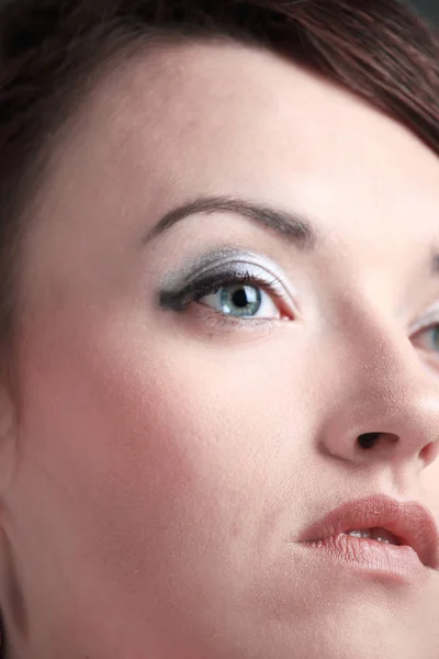 Closeup. a young woman with daily makeup looks up — Stock Photo, Image