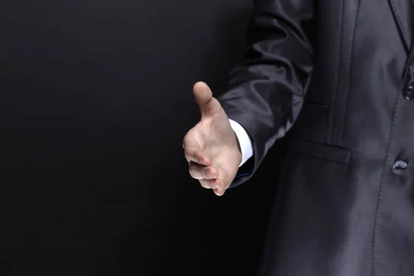 Sluit up.businessman, uitdelen voor een handshake.isolated op zwarte achtergrond — Stockfoto